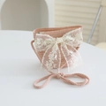 Detailed macro view of a pink woven straw bag for girls with a large white lace bow detail - 52cm (3-6 Years) / Bag / Pink