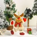Detail of plush reindeer Christmas ornament with red scarf on snowy festive background - Dancing Reindeer