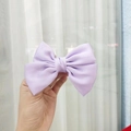 Elegant purple satin oversized bow hair clip held by hand for a refined hairstyle - Kids Duckbill Clip / Purple