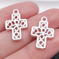 Pair of silver-tone hollow metal cross charms with intricate scroll patterns for DIY jewelry - Hollow 19x13mm (1.1g)