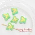 Macro detail of 16x20mm UV coated acrylic bow beads with 2.5mm hole for DIY crafts - Green