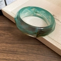 Close-up of green resin bangle with brown marble texture on a neutral display tray - Blue Marble Pattern Wide Bangle (#15 - Blue)