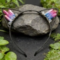 Detail of cat ear headband with pink and blue gradient crystals on a dark grey stone - AB Blue Red Cat Ears