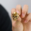 Detailed close-up of a vintage golden skull ring for men with Gothic design elements - US 10 / Gold