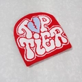 Detail of red Y2K beanie featuring Top Tier text and blue broken heart graphic print - One Size / Red