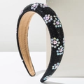 Detail of wide black headband with colorful rhinestone flower patterns and padded texture - Black