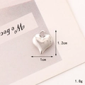 Macro detail of a 3D heart-shaped silver charm with 1cm dimensions and polished finish - C292 10mm*12mm Silver Heart