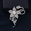 Elegant silver flower brooch with white pearl and sparkling zircons on blue velvet - Silver
