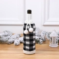 Knitted Christmas wine bottle cover with black white plaid design and white pom poms - Black White Grid