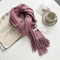 Soft purple pashmina scarf with fringe details and woven label on a table - Peony Pink