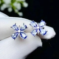 Elegant flower earrings with blue teardrop zircons on a silver-plated metal base - White Gold