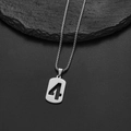 Macro shot of silver stainless steel square box chain and number 4 pendant on rock - Number 4