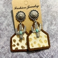 Detail of western earrings with cactus metal charm and leopard print fur in wood frame - Leopard Faux Fur