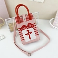 Close-up of pink knit crossbody bag with red mahjong character and round handle - 28-Pink White Red-Zhong