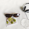 Retro tortoiseshell oval sunglasses with dark lenses displayed on artistic card - Transparent Tea