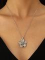 Textured silver flower pendant necklace for women worn by a model on a black top - Silver Flower Necklace (6998)