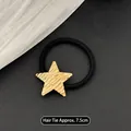 Minimalist elastic hair tie with textured gold star alloy charm on black leather base - Five-pointed Star Gold