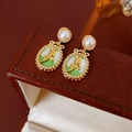 Vintage gold rose earrings with green enamel and pearl on a brown leather jewelry box - Green Enamel Rose Pearl Studs
