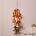 55cm Christmas swag with warm LED lights featuring pine cones and Santa dolls - 55cm Rattan Swag with LED