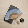Blue silk folding fan with intricate hollowed bamboo ribs and elegant silver grey tassel - Blue / 23CM
