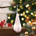 Pink striped Christmas gnome ornament hanging on tree with warm bokeh background - Pink Style B