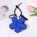 Blue puffy flower keychain with black metal clip on a desk with coffee and tulip - Black Blue