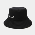 Detail of a black cotton bucket hat featuring a silver safety pin with sparkling rhinestones - Black