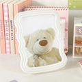 White wave-shaped desktop vanity mirror with foldable stand and clear reflection - White