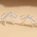 Close-up of minimalist silver bow stud earrings with a polished metallic finish - ES2560 Smooth Bow