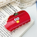 Cute red apple acrylic hair claw clip with cartoon face on open book background - Apple