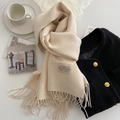 Beige faux cashmere scarf with tassels paired with a tweed jacket in a lifestyle flat lay - 200x68cm / Beige