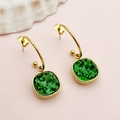Detailed close-up of vintage gold earrings featuring large square emerald green zircon stones - Emerald Green