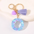 Letter O keychain featuring purple heart charm and suede tassel with gold hardware - Letter O