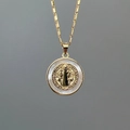 Detailed close-up of a gold-plated Saint Benedict medal with white mother-of-pearl inlay - Style D (Round St. Benedict Medal)