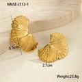 Detailed view of fan-shaped gold earrings with natural metal texture on stone surface - Gold Fan Earrings