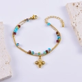 Bracciale bohémien dorato con perline colorate e ciondolo a forma di fiore - Stile Fiore