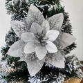 Macro view of silver poinsettia ornament with glitter on a snowy Christmas tree branch - 14.5cm / Silver