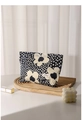 Detail of floral makeup bag with blue fabric and cream flower patterns on a wooden tray - Blue Floral