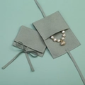 Sage green microfiber jewelry pouch with flap closure and matching tie ribbon detail - Light Green