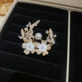 Nahaufnahme einer 14k vergoldeten Brosche mit Zirkonia, Perlen und Blumenblättern - Mond und Blumen Stil - Gold (5#)