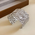 Detail view of silver wide open cuff bracelet with artistic hammered lava texture - Silver Irregular Hammered Flow Style