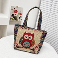 Close-up of ethnic embroidered owl pattern on handmade woven tote bag with colorful handles - Red Owl