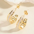 Detailed macro view of vintage gold crescent earrings with white enamel and hammered texture - ES2388-1 C-Shape Enamel Earrings