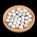 White marble round stone beads for DIY jewelry making displayed in a wooden tray - 12mm Howlite Semi Drilled Bead