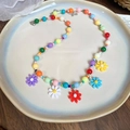 Close-up of colorful beaded necklace with five resin daisy flower charms in pastel tones - Colorful Flower Tassel Style (10#)