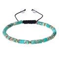 Detail of turquoise natural stone beads with gold spacers on black braided cord - Natural Stone