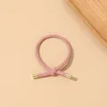 Detail of pink high-elastic braided hair tie with gold metal clasp on beige background - Ribbed Knot - Metal Buckle / Pink