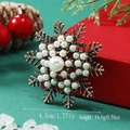 Macro detail of snowflake brooch with pearls and gold finish, sized 4.5cm and 16.6g - Pearl Snowflake (WBR094)