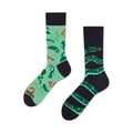 Detail of mismatched socks featuring mint green reptile print and black coiled snake design - Green Snake