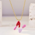 Macro detail of 'R' letter pendant featuring colorful pink and red enamel segments - Letter N